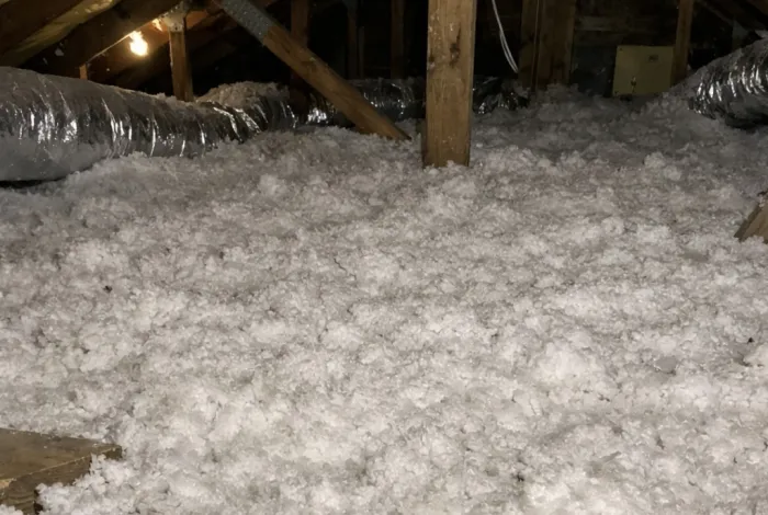 Fresh R-38 blown-in insulation installed across an attic floor